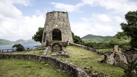 Historic Tower Among Scenic Ruins in a Serene Landscape wallpaper