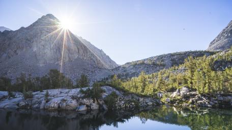 Majestic Mountain Sunrise Over Serene Lake wallpaper