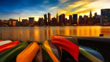Colorful Canoes Against a Stunning New York City Skyline wallpaper