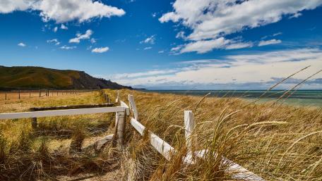 Tranquil Coastal Landscape Under Wide Blue Skies wallpaper