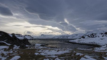 Majestic Winter Landscape Under Dramatic Skies wallpaper