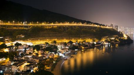 Glistening Night Cityscape Overlooking the River wallpaper