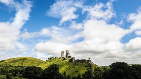 Majestic Castle Ruins on a Green Hilltop wallpaper