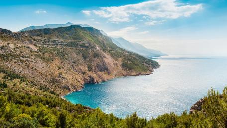 Serene Coastal Landscape with Majestic Mountains wallpaper