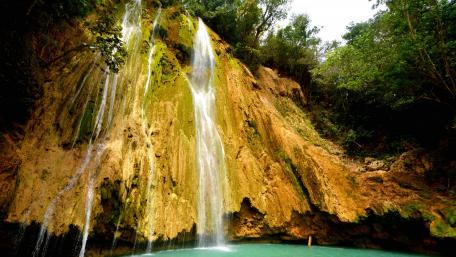 Serene Waterfalls Amidst Lush Greenery wallpaper