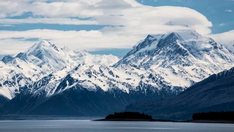 Majestic Snow-Capped Mountains Under a Blue Sky wallpaper