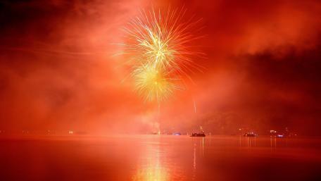 Majestic Fireworks Over a Red Night Sky wallpaper