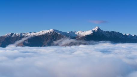 Majestic Alpine Clouds Over Mountain Peaks wallpaper