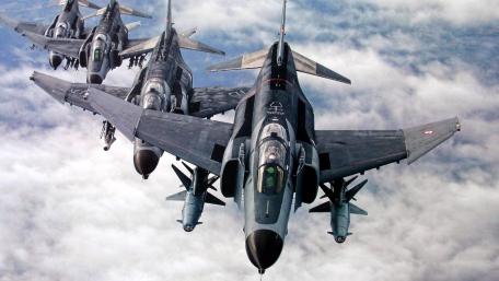 Fighter Jets in Formation Above the Clouds wallpaper