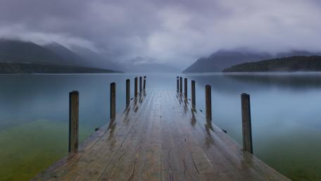 Misty Pier Over Calm Lake wallpaper