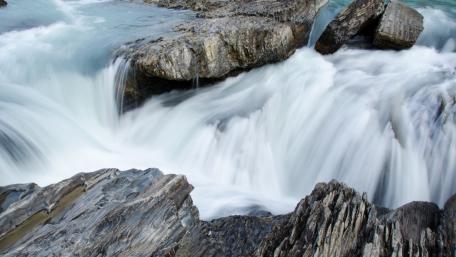 Serene River Cascade in Nature's Embrace wallpaper