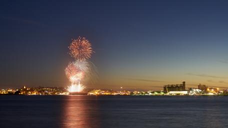 Fireworks Over the Cityscape at Dusk wallpaper