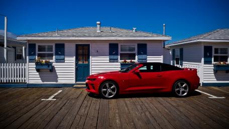 Sleek Red Sports Car by Quaint Beach House wallpaper
