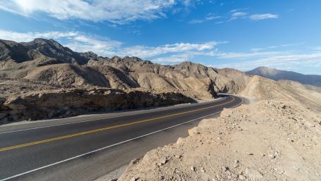Winding Road Through Majestic Mountains Renovating Nature's Beauty wallpaper