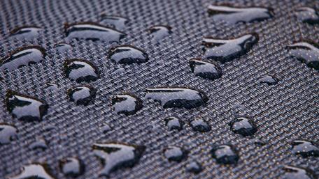 Water on textured material wallpaper