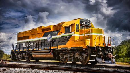 Powerful Yellow Locomotive on Railway Tracks in 4K wallpaper