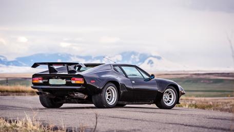 Sleek Black Sports Car on Open Road wallpaper