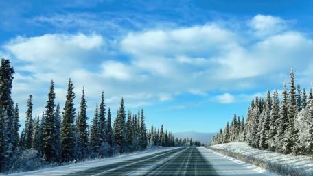 Winter Road Through a Snowy Landscape wallpaper