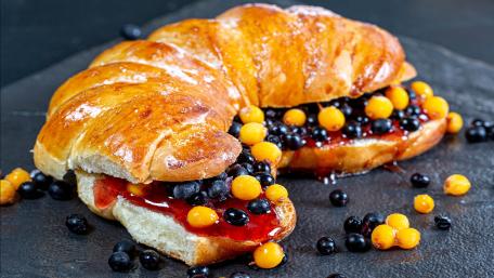 Deliciously Indulgent Croissant with Berries and Jam wallpaper