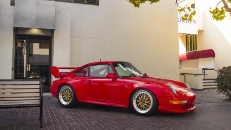 Vibrant Red Porsche in Urban Setting wallpaper