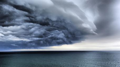 Dramatic Clouds Over Serene Sea View wallpaper