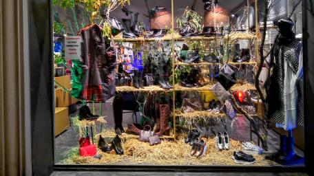 Unique Shop Window Display Showcasing Stylish Footwear and Fashion Accessories wallpaper