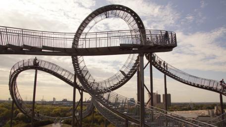 Thrilling Cityscape with a Roller Coaster Experience wallpaper