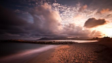 Tranquil Beach at Dusk with Dramatic Clouds wallpaper