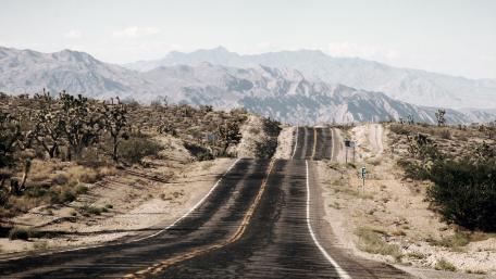 Winding Road Through Majestic Mountains wallpaper