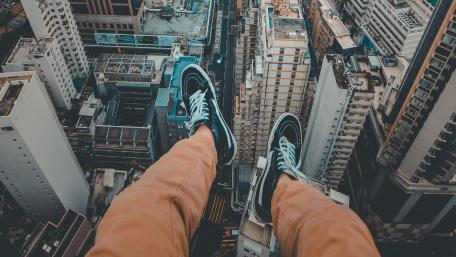 Dangling Feet Above The Metropolis wallpaper
