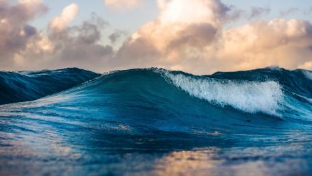 Majestic Blue Ocean Wave at Sunset wallpaper