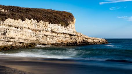 Silent Coastal Beauty with Waves Dancing Along the Shoreline wallpaper