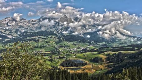 Majestic Alpine Highlands Under a Cloudy Sky wallpaper