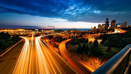 Urban Nightscape with Glowing Light Trails wallpaper