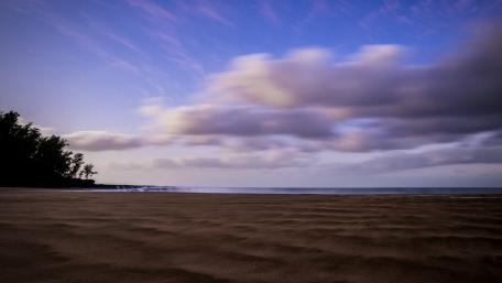 Tranquil Shoreline Under a Serene Sky wallpaper