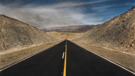 Endless Highway Through Serene Landscapes wallpaper