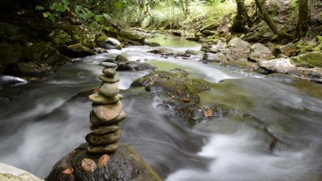 Serene Stone Balancing by the Waterfall wallpaper
