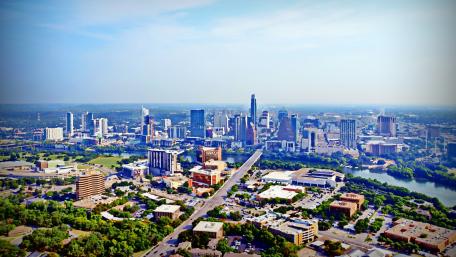 Vibrant City Skyline Under a Clear Blue Sky wallpaper