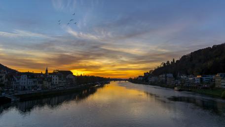 Serene Sunset Over River Cityscape wallpaper