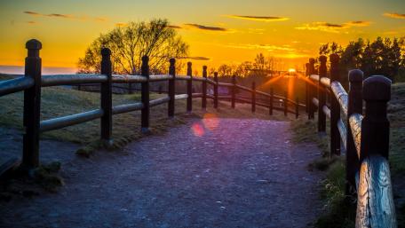 Pathway to Serenity Under a Vibrant Sunset wallpaper