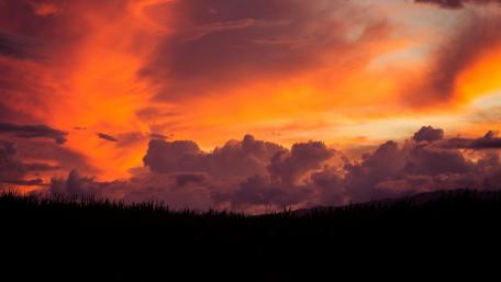 Fiery Sunset Over Serene Landscape wallpaper