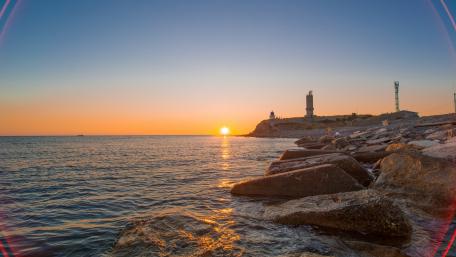 Tranquil Sunset by the Lighthouse wallpaper