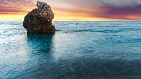 Majestic Sea Stack at Sunset Horizon wallpaper