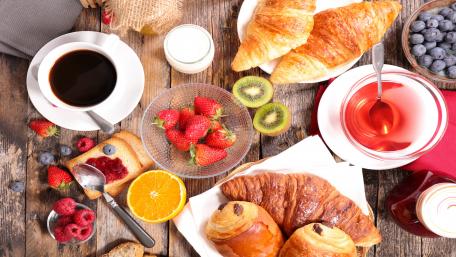 Delightful Breakfast Spread with Croissants and Fruits wallpaper