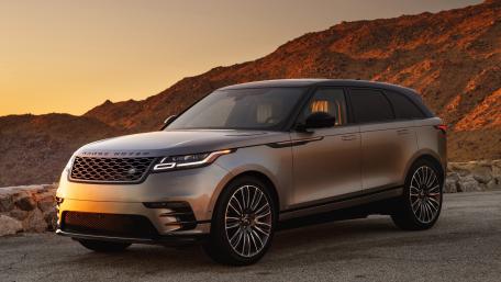 Sleek Range Rover Against a Scenic Sunset Background wallpaper