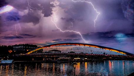 Thunderstorm Over Vibrant City Bridge wallpaper