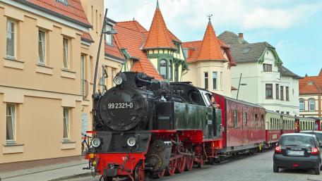 Vintage Train in a Charming City Setting wallpaper