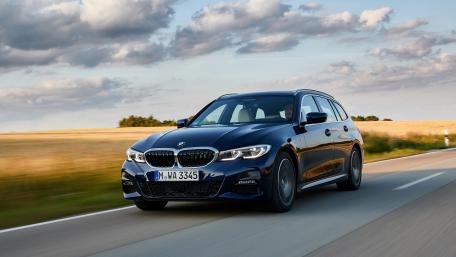 Sleek BMW 3 Series in Motion Amidst Nature's Beauty wallpaper