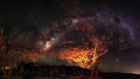 Starry Night Cascade Over Burnished Horizon wallpaper