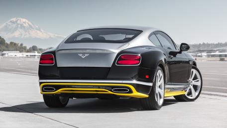 Sleek Luxury Car Against Majestic Mountain Background wallpaper